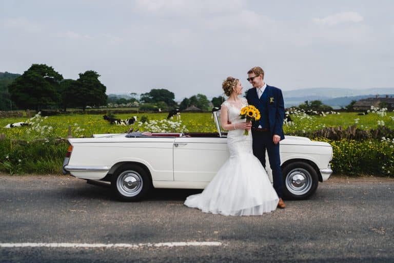 Bride and Groom In countryside with car